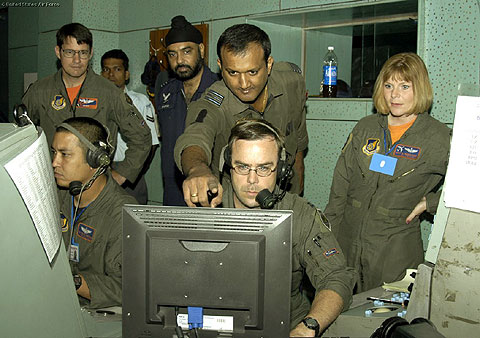 SALUA AIR STATION, India -- Senior director Capt. Michael Thomas (lower center), lead weapons director Tech. Sgt. Steven Harshman (lower left) and Indian Air Force Squadron Leader Rajesh monitor and direct aircraft from their "E-3 Sentry" during Cope India 06. Watching the war games are (back left) Lt. Col. Peter Bastien, 961st Airborne Air Control Squadron detachment commander, Indian air force wing Commander Singh (back center) and Master Sgt. Belinda Magilligan (back right), a weapons director. This is the third Cope India exercise since 2002. (U.S. Air Force photo by Tech. Sgt. Martin Jackson)